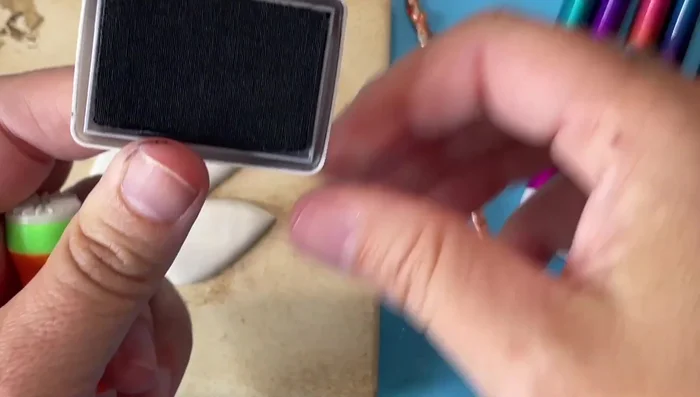 Use archival ink and stamps to add a scrimshaw-like design to the bird.