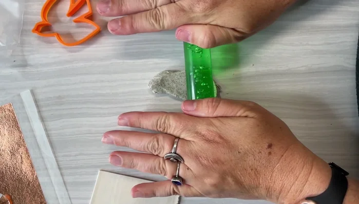 Lightly attach the clay to a small tile for baking.