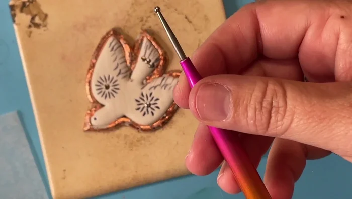 Use a ball stylus to add a hammered metal texture to the copper leafing.