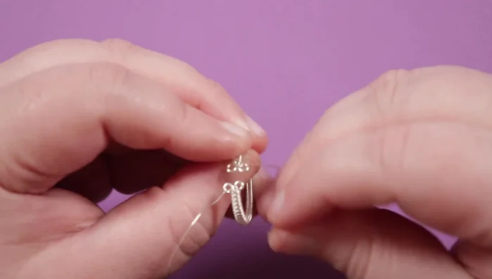 Connect the loops using the weaving wire tails, creating a platform for the top piece. Securely wrap the weaving wires around the loops and the base wires.