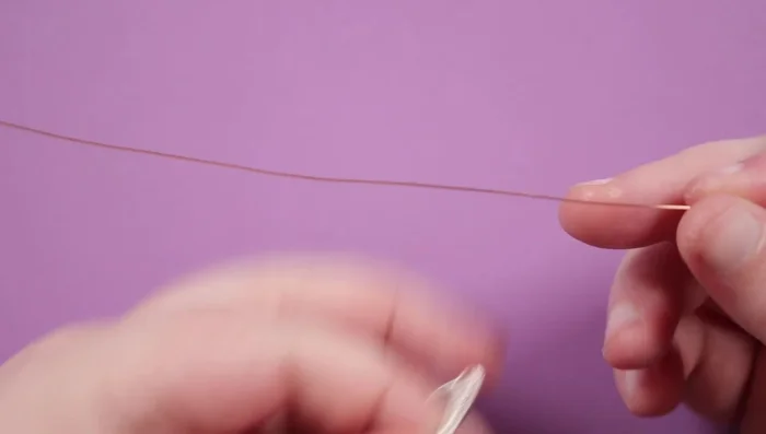 Create the top piece using the copper wire (0.4 mil). Use round nose pliers to form two small circles, doubling the wire to create a sturdy base.