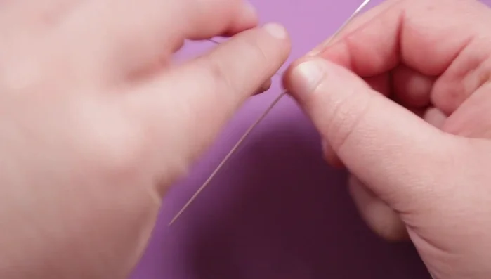 Create the ring band using a diagonal wire weave with two base wires (0.8 mil) and one weaving wire (0.4 mil). Continue weaving until you reach the desired ring size. Use a scrap wire wrapped around your ring mandrel to gauge the necessary length.