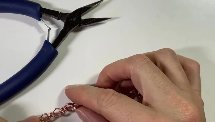 Add a clasp (e.g., 16 gauge swan clasp and jump ring).