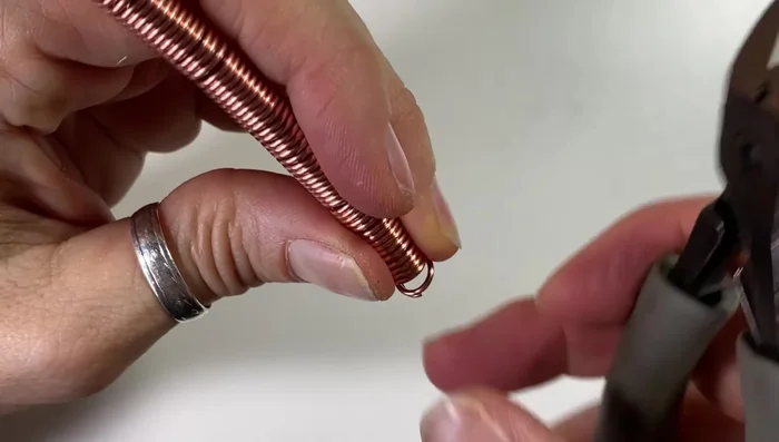 Cut the coil to create split rings by skipping a ring between each cut. Ensure all ends are flush.