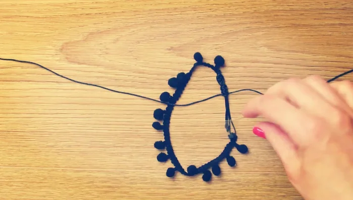 Open the sliding knots, adjust the anklet on your ankle, and tighten.