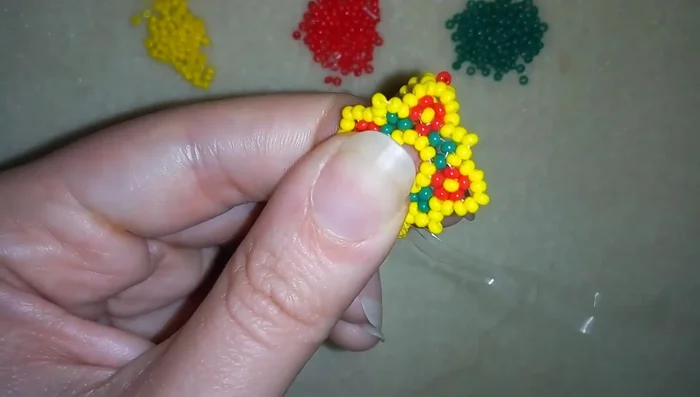 Create a loop, go through twice and pull tight to secure the end. Trim the excess thread.