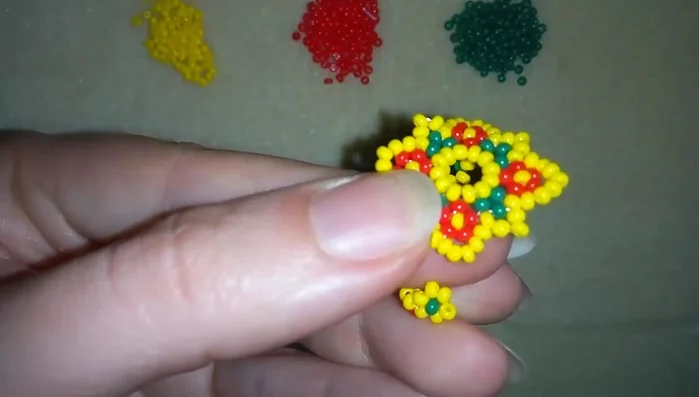 Secure the connection by adding two more yellow beads and going through the previous yellow bead. 