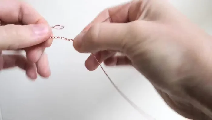 Continue twisting until the wire reaches almost to the bottom of the cabochon.