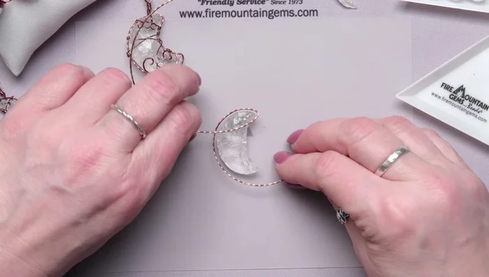 Bend the wire at the tips and massage it to follow the moon's curve.