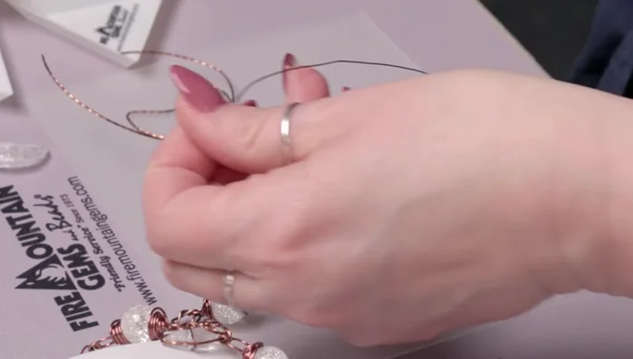 Use round nose pliers to create small curly cues on the twisted wire tails.