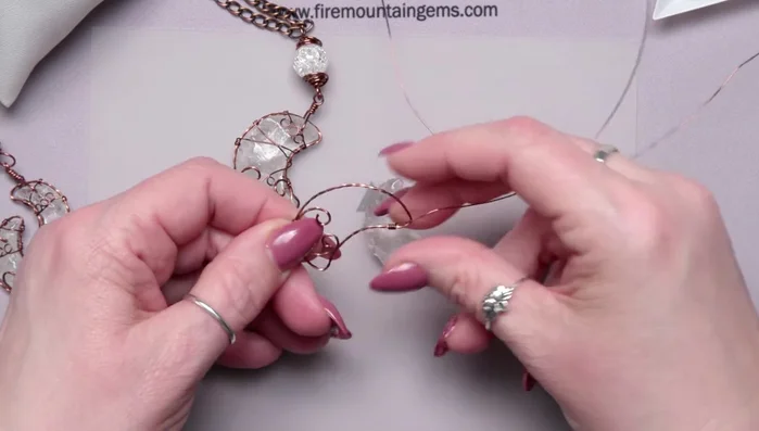 Create loops in the 24 gauge wire using round nose pliers to add detail.