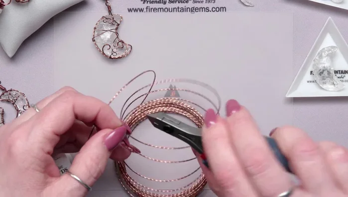 Bend the wire at the tips and massage it to follow the moon's curve.