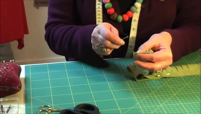 Stitch together the end of the fringed fabric with three or four stitches for strength and stability.