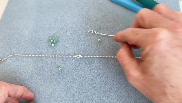 Cut the necklace at the determined points, leaving the clasp in the center.