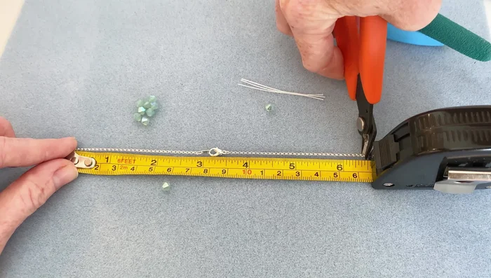 Cut the necklace at the determined points, leaving the clasp in the center.