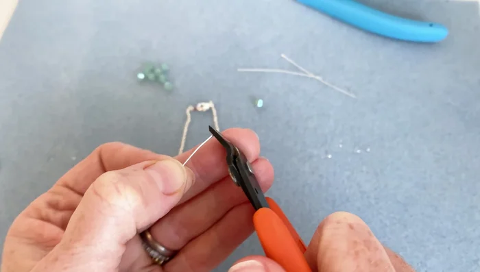 Add the focal bead: Attach your chosen bead(s) to the head pin above the loop.