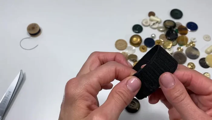 Arrange your buttons on the elastic, overlapping them slightly to hide the elastic and create a visually appealing design. Consider color and size variations.