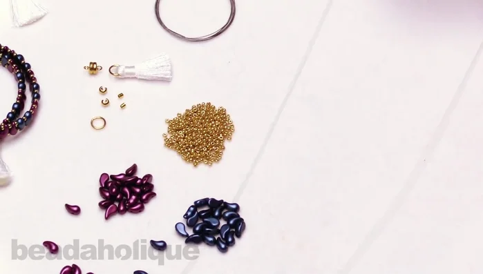 Crimp the tube using crimping pliers to create a secure V-shape. Repeat the crimping process to fully secure the clasp.