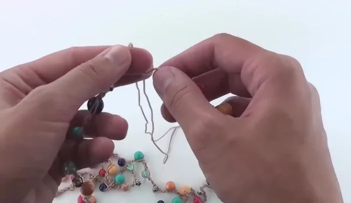 Tie the beginning and ending thread ends together several times and secure with clear nail polish or jewelry glue.