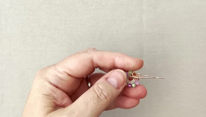 Cut excess wire and neaten the ends. Add an ear wire to complete the earring. Repeat steps for the second earring.