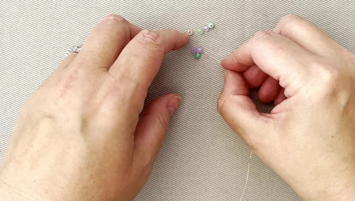 Wrap the wire around the crystals several times, ensuring not to pull too tightly. Gently adjust placement with your fingers.