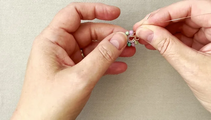 Wrap the wire around the crystals several times, ensuring not to pull too tightly. Gently adjust placement with your fingers.