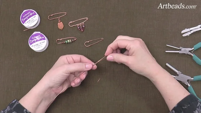 Straighten and shape the hook: Straighten the twisted wire using pliers to create a nice, even hook. Use the largest mandrel on the Weber pliers to roll the end into a hook, then use the smaller mandrel to curve it slightly.