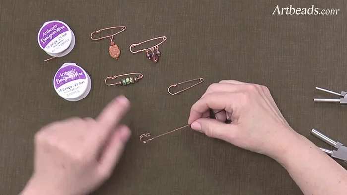 Add beads or loops (optional): Add beads or create loops for dangling elements along the wire before forming the final loop.