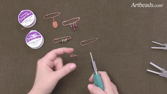 Form the final loop: Using the larger end of the small Weber pliers, create a loop at the end of the hook, wrapping the wire tightly around the pliers and extending past the hook for tension.