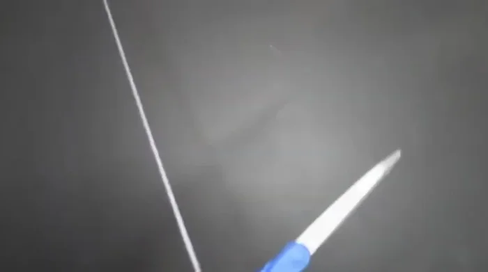 Cut the yarn and prepare a separate piece of yarn for tying.