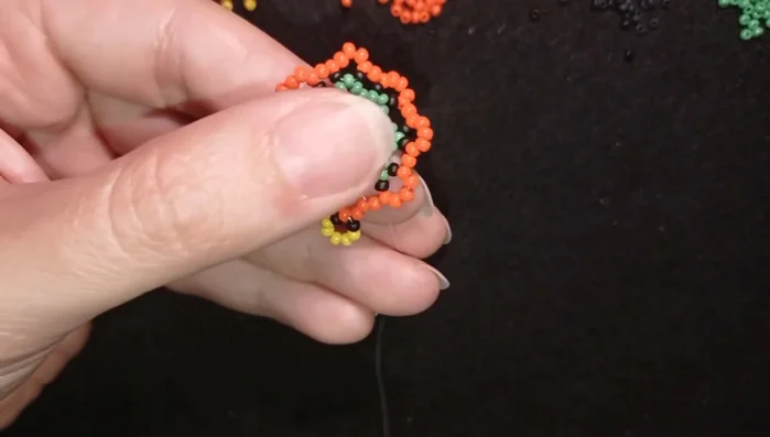 Create the inner angle elements by adding black, yellow, black sequences. Repeat this process for both inner and outer angles, creating a pattern.