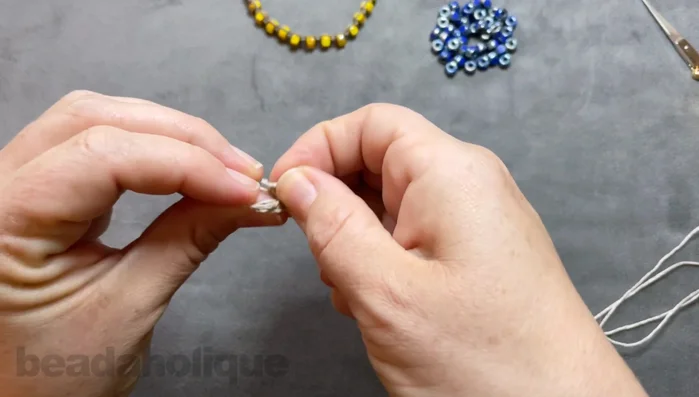 Secure the knot to the macrame board.