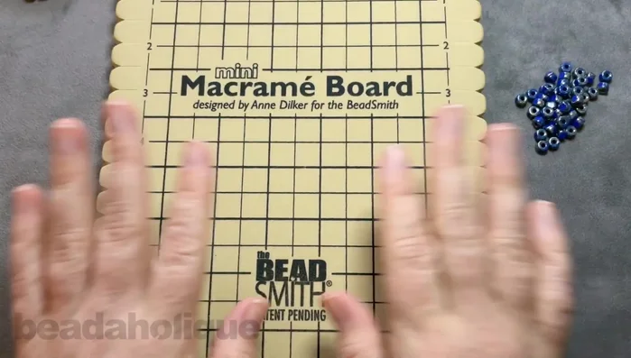 Secure the knot to the macrame board.