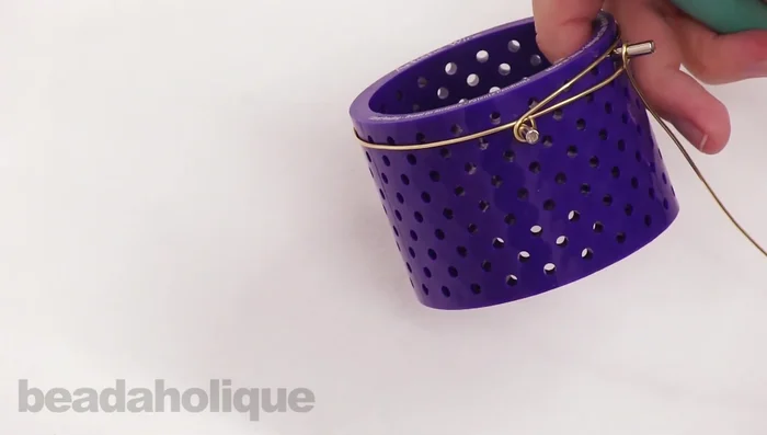 Using a mandrel or household item (approx. 6-6.5 inches in circumference), carefully bend the wire into a bangle shape. Use your wire rounder tool to smooth the ends.