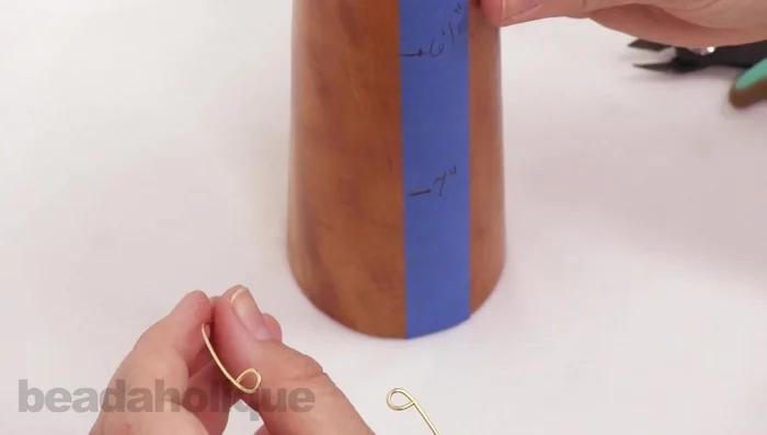 Using a mandrel or household item (approx. 6-6.5 inches in circumference), carefully bend the wire into a bangle shape. Use your wire rounder tool to smooth the ends.