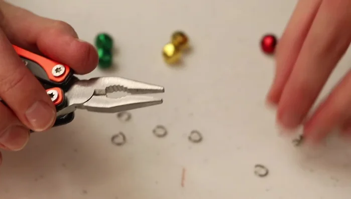 Attach the O-ring with the jingle bell to the earring hook. Close the O-ring securely using the pliers.