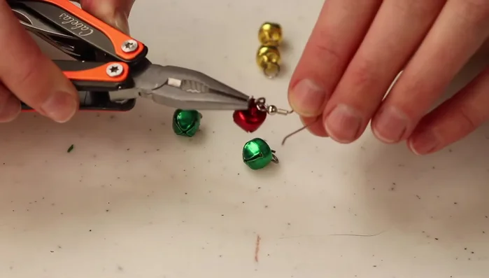 Attach the O-ring with the jingle bell to the earring hook. Close the O-ring securely using the pliers.