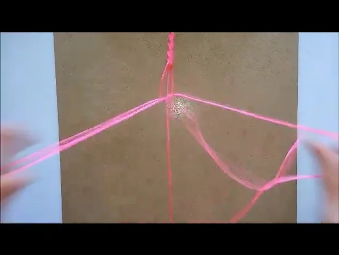 Continue adding beads, securing each with square knots.