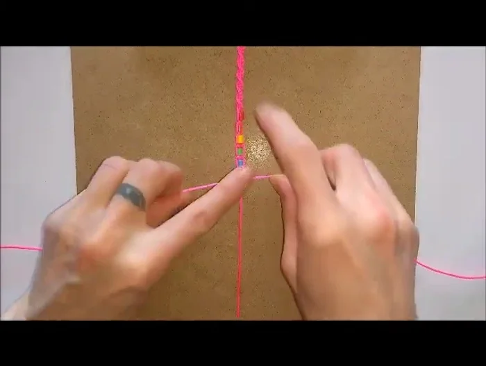 Once all beads are added, return to the initial knotting style used for the spiral, securing the end.