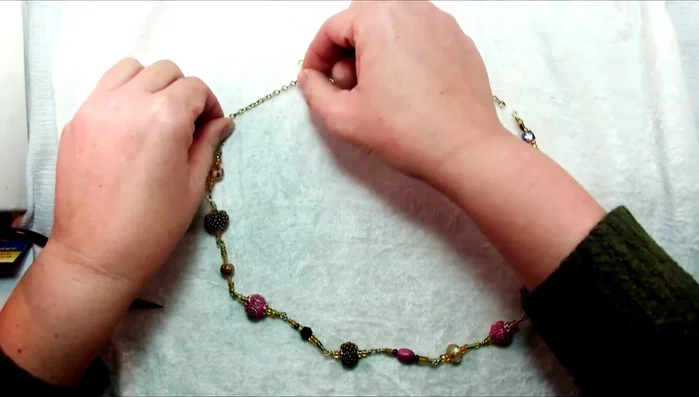 Finish the necklace: Add chain, jump rings, and the lobster clasp. Open jump rings by pulling from side to side, not by spreading them.