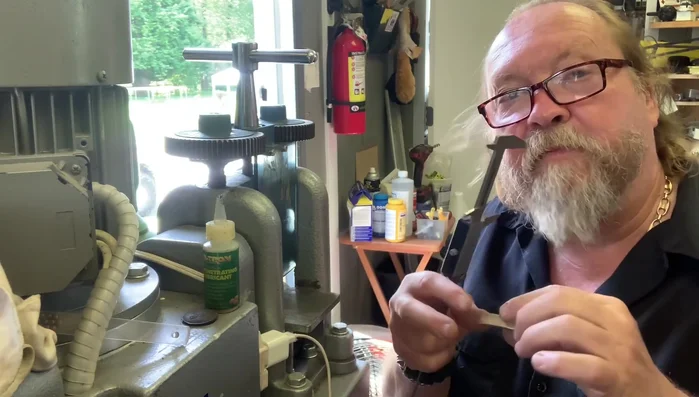 Square up ends and hammer texture: File the ends of the ingot to square them. Use a hammer to create the hammered texture on the surface of the ring.