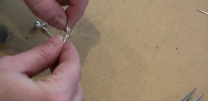 Adjust the loops to ensure they sit properly for the ear wire attachment.