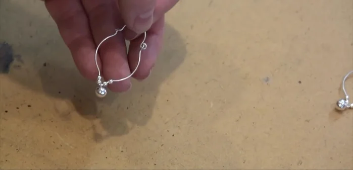 Finesse the earring and ear wire connections to ensure a secure and comfortable fit.