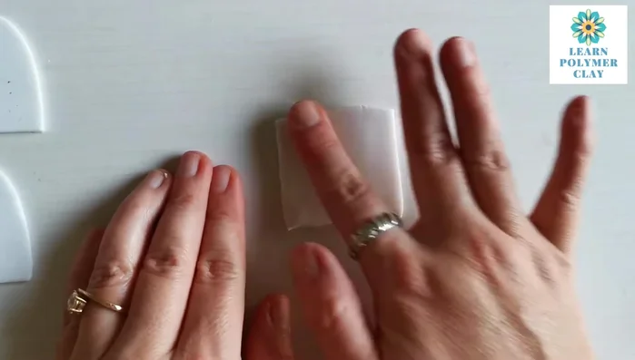 Roll clay paste through the pasta machine (medium setting) and fold in half for a double layer. Apply a floral texture using a roller to create a pattern.