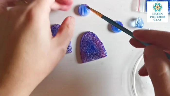 Assemble the earrings using jump rings, silver wire, and seed beads. Create loops with the wire around the different components.