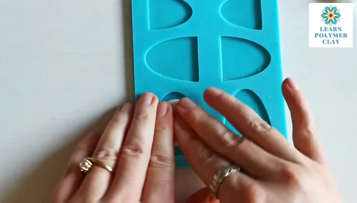 Condition translucent polymer clay and roll into a bowl shape. Press into a bakeable mold, using fingers and a roller to spread evenly and remove air bubbles.