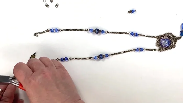 Attach clasps: Attach the lobster claw or swivel clasp to each end of the necklace using jump rings.