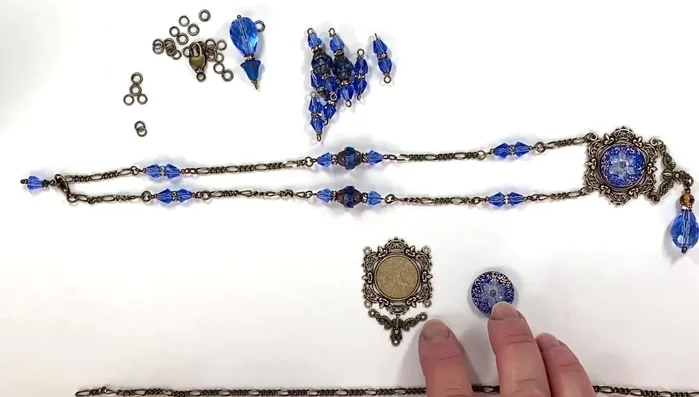 Attach the center stone and hanger: Attach the prepared hanger (CHM04485) to the back of the center stone setting.