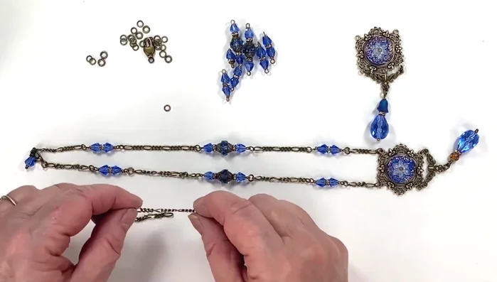 Assemble side sections: Attach the prepared side chain accents to the main chain, using jump rings.