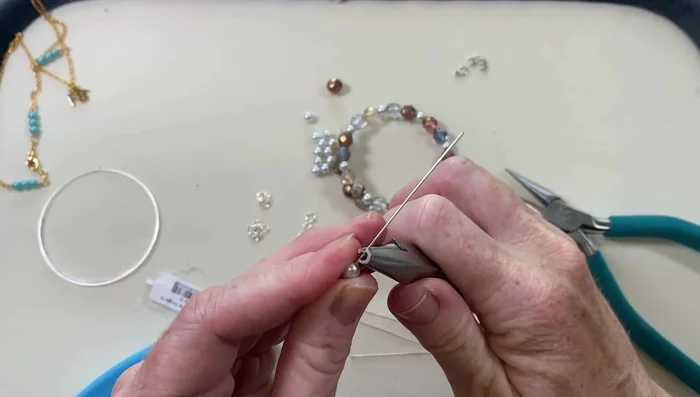 (Optional) Add extra decorative elements, such as small wire loops, for added personalization.